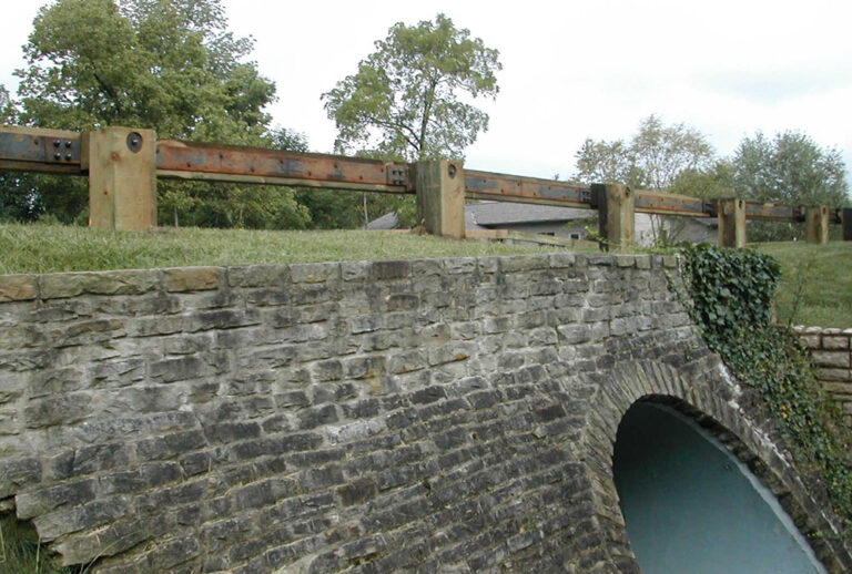 Steel Backed Timber Rail Over Stone Bridge
